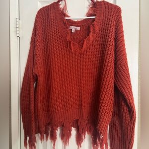 Orange red knit sweater size large , bottom edge fringe detail